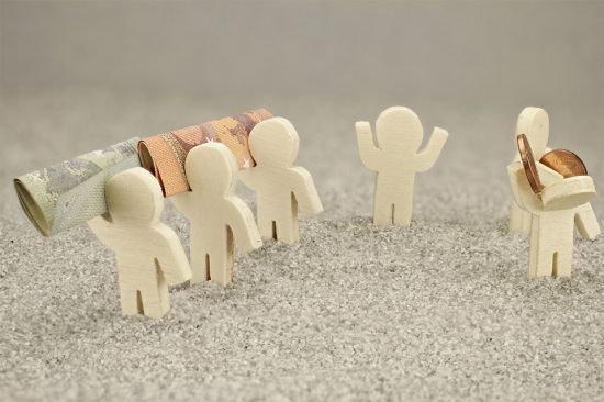 Foto: Kleine Figuren mit Geldscheinen und Münzen